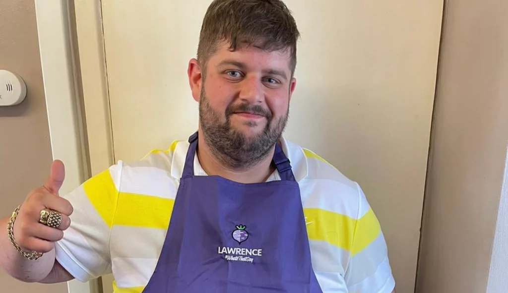 Lawrence Green smiling with apron